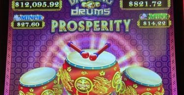 Dancing Drums Prosperity by Scientific Games logo and progressives
