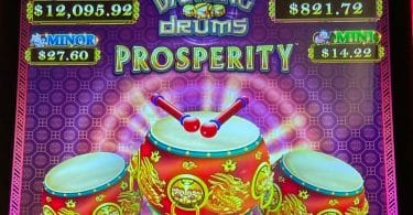 Dancing Drums Prosperity by Scientific Games logo and progressives